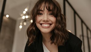 Smiling young woman with a softly-tousled wolf cut